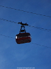 Pendelbahn Trittkopf Zürs, die Sonne hinter einem Wagen